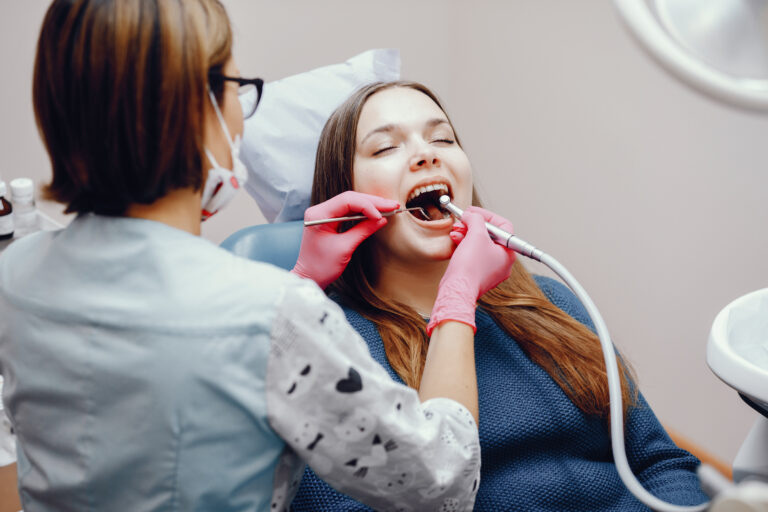 Beautiful girl sitting in the dentist's office