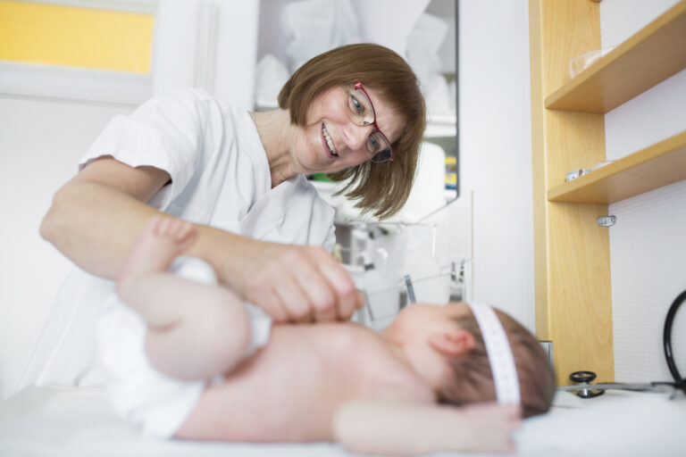 Pediatrician performing a checkup on a baby at the clinic