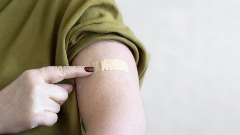 woman-with-bandage-arm-after-vaccination